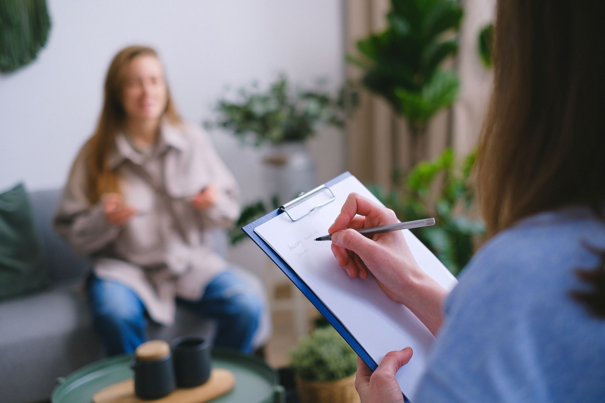 Behavioral health professional taking notes during a client session